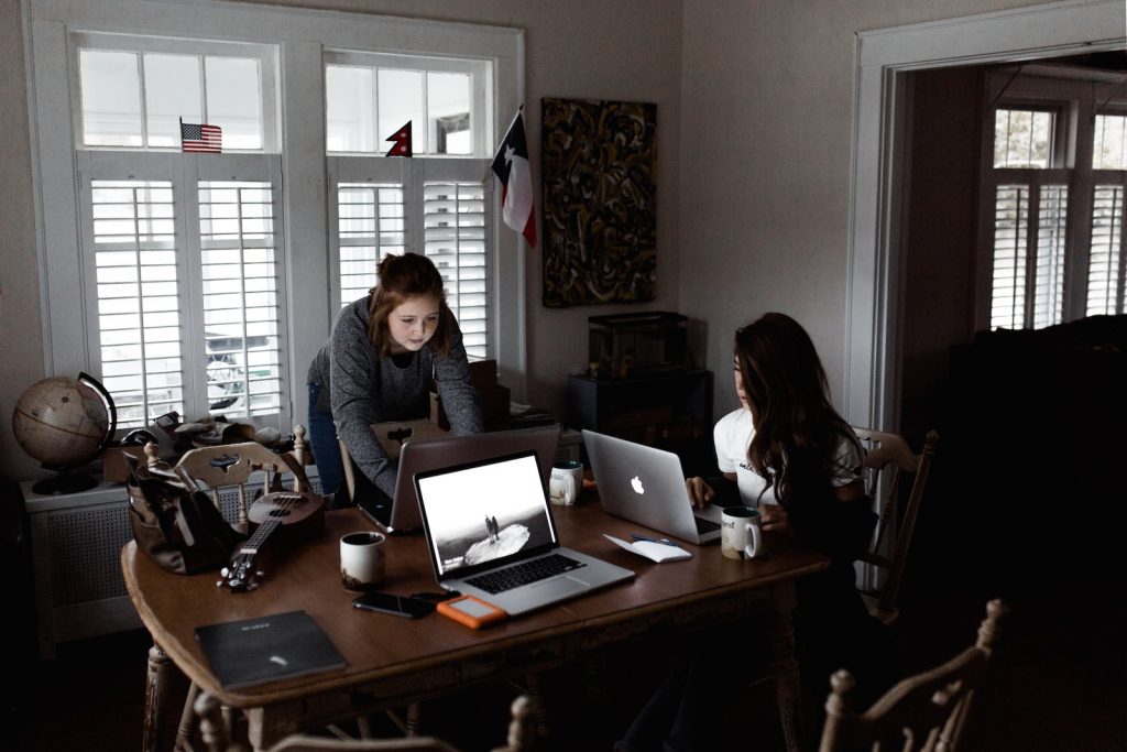 Two handbag designers at work