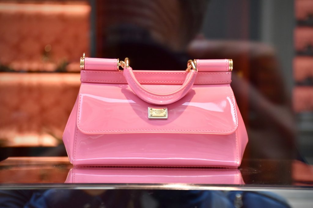 a pink purse sitting on top of a table